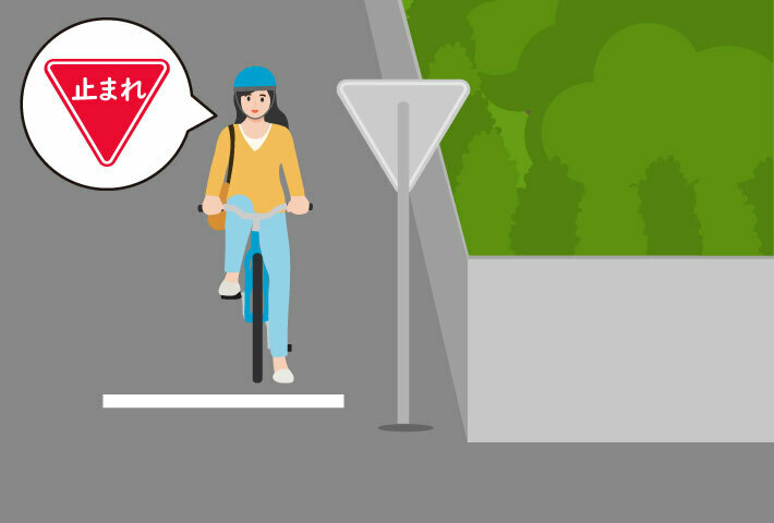 一時停止をする自転車に乗る女性
